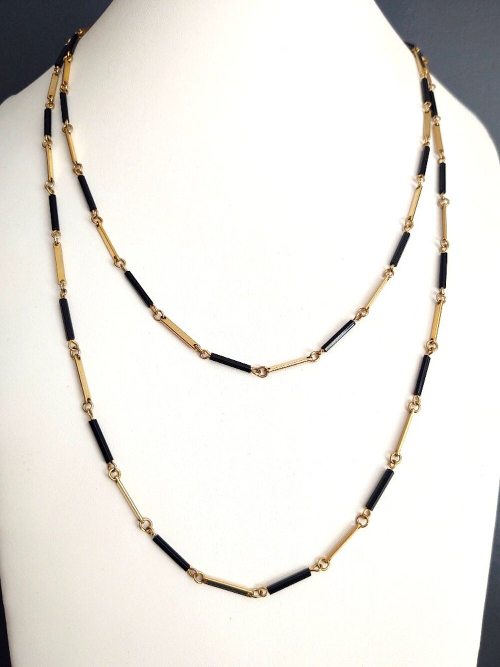 Long single strand gold and black delicate necklace